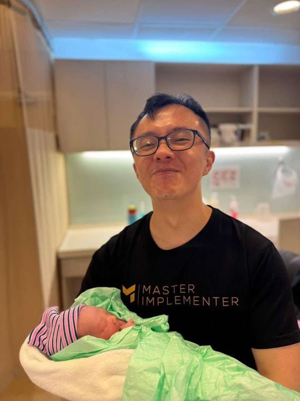 Marc holding his newborn son